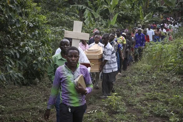 The coffins of Florence Masika and her son Zakayo Masereka, who were both killed by suspected rebels as they retreated from Saturday's attack on the Lhubiriha Secondary School, are carried to their burial in Nyabugando, Uganda Sunday, June 18, 2023. A bereaved Ugandan border town on Sunday began burying the victims of the brutal attack by suspected extremist rebels that left at least 42 people dead, most of them students, as security forces stepped up patrols along the frontier with volatile eastern Congo. (Photo by Hajarah Nalwadda/AP Photo)