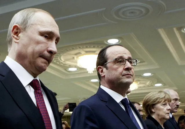 Russian President Vladimir Putin, French President Francois Hollande, Ukraininan President Petro Poroshenko (covered), German Chancellor Angela Merkel and Belarussian President Alexander Lukashenko (L-R) walk after a meeting in Minsk, February 11, 2015. (Photo by Valentyn Ogirenko/Reuters)