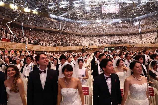 Thousands of couples attend a mass wedding held by the Family Federation for World Peace and Unification, aka Unification Church on August 27, 2018 in Gapyeong-gun, South Korea. Some 4,000 “Moonies”, believers of Unification Church, which was named after the founder Moon Sun Myung, attend the mass wedding which began in the early 1960s. (Photo by Chung Sung-Jun/Getty Images)