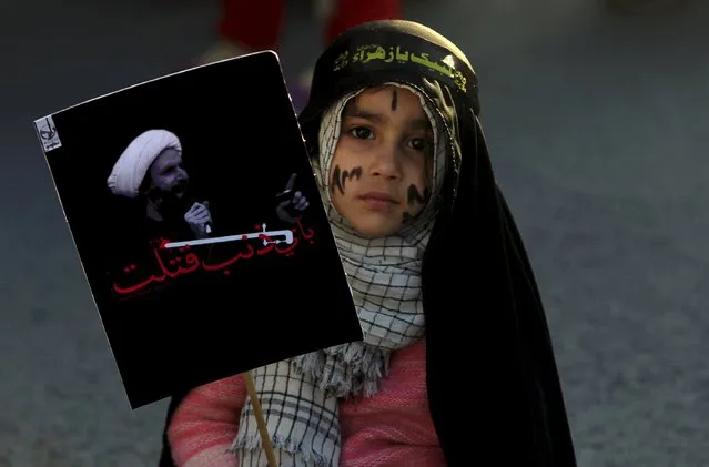 A Shi'ite Muslim girl holds a picture of Shi'ite Muslim cleric Nimr al-Nimr, who was executed along with others in Saudi Arabia, as she takes part in a protest rally in Islamabad, Pakistan, January 8, 2016. (Photo by Faisal Mahmood/Reuters)