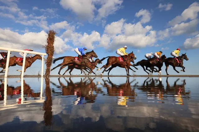Jockeys and their horses reflect in the water of Laytown Beach during the third race of the day at the Laytown Races in Co Meath, Ireland on Tuesday,  September 12, 2023. (Photo by Dara Mac Dónaill/The Irish Times)