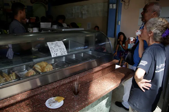 A placard reading “100 bolivar notes are not accepted” is posted at a snack bar near Venezuela's Central Bank in Caracas, Venezuela December 16, 2016. (Photo by Marco Bello/Reuters)