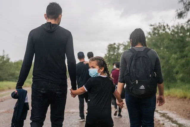 Immigrants seeking asylum walk towards border patrol after crossing into the U.S. on June 16, 2021 in La Joya, Texas. A surge of mostly Central American immigrants crossing into the United States has challenged U.S. immigration agencies along the U.S. Southern border. (Photo by Brandon Bell/Getty Images)