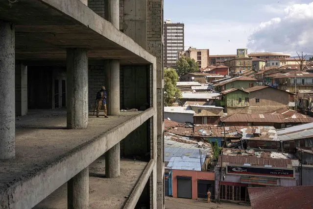 A security guard walks on the edge of an unfinished building in the historical Piazza neighbourhood of Addis Ababa on October 21, 2023. (Photo by Michele Spatari/AFP Photo)