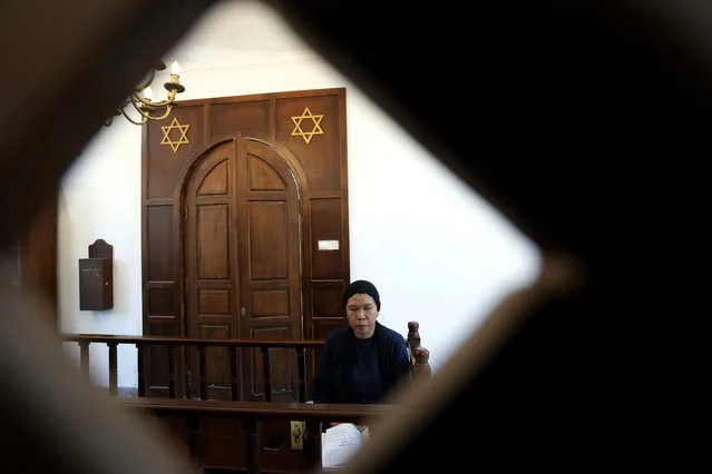 A woman prays at Shaar Hashamayim Synagogue in Tondano, North Sulawesi, Indonesia, Saturday, October 14, 2023. An Indonesian rabbi at the only synagogue in the world's most populous Muslim-majority nation, called on Saturday for peace and an an end to the fightings in Israel and Gaza. (Photo by Tatan Syuflana/AP Photo)