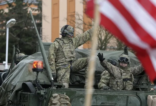 US army soldiers wave to their supporters as they arrive with their convoy in Prague, Czech Republic, Monday, March 30, 2015. (Photo by Petr David Josek/AP Photo)