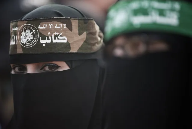 A Palestinian woman wears a headband with Arabic that reads: “No God but Allah and Muhammed is his messenger, al-Qassam Brigades” during a mass rally marking the 31st anniversary of the founding of Hamas, an Islamic political party, which has an armed wing of the same name, that currently rules in Gaza, Sunday, December 16, 2018, in Gaza city. (Photo by Khalil Hamra/AP Photo)