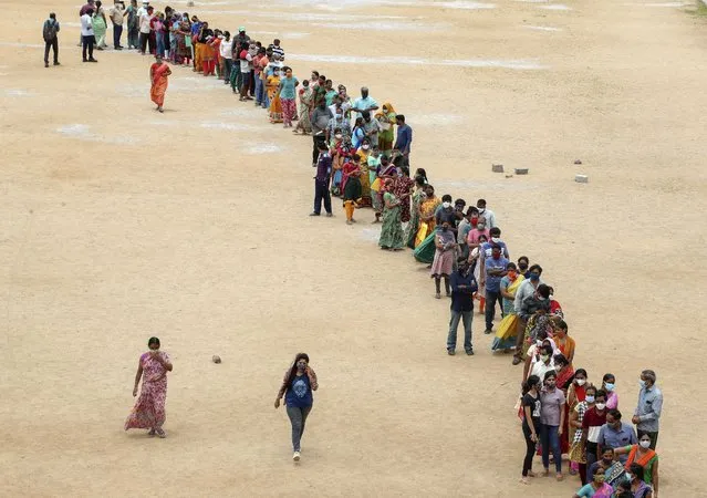 Hundreds of people line up to receive their second dose of vaccine against the coronavirus at the municipal ground in Hyderabad, India, Thursday, July 29, 2021. (Photo by Mahesh Kumar A./AP Photo)