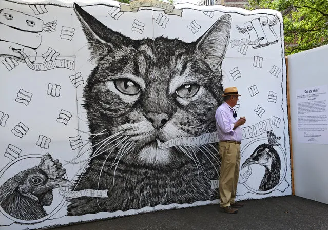 Erle Bridgewater reads information near the artwork of Jeff Whipple, Wednesday, April 8, 2015, in Jacksonville, Fla., during One Spark 2015, a crowdfunding event with over 500 projects. (Photo by Bob Mack/AP Photo/The Florida Times-Union)