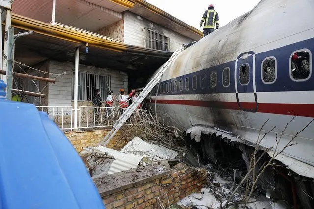 A picture taken on January 14, 2019 shows a Boeing 707 cargo plane that reportedly crashed into a residential complex near the Iranian capital Tehran with at least 10 people onboard. The plane overshot the runway during its landing, Iran's aviation organisation spokesman Reza Jafarzadeh told state broadcaster IRIB. (Photo by Hasan Shirvani/AFP Photo)