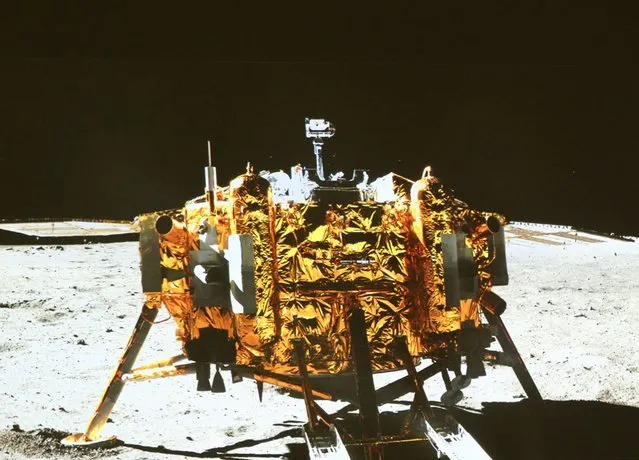 This image taken by the on-board camera of the “Yutu”  or “Jade Rabbit”  rover, and made off the screen of the Beijing Aerospace Control Center in Beijing on Sunday, December 15, 2013,  shows a photo of the Chang'e-3 lander during the mutual-photograph process. The rover and the lander took photos of each other Sunday night, marking the success of the Chang'e-3 lunar probe mission. (Photo by Ding Lin/AP Photo/Xinhua)