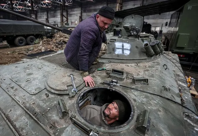 Servicemen of the National Guard of Ukraine repair a captured Russian infantry fighting vehicle, as Russia's attack on Ukraine continues, in Kharkiv region, Ukraine on November 3, 2022. (Photo by Vyacheslav Madiyevskyy/Reuters)