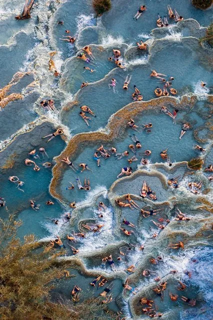 Cascate del Mulino. People Commended. Tourists in the natural thermal pools in Saturnia, Tuscany, northern Italy, each one assuming a different position of relaxation. (Photo by Christian Gatti/Drone Photography Awards 2021)