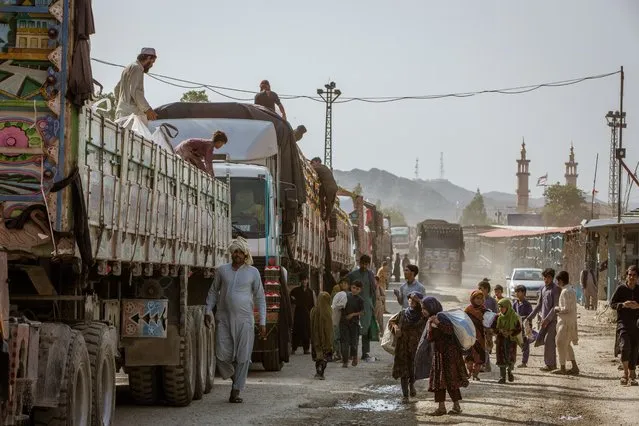 On the Afghan side of the border with Pakistan, children try to hide in trucks to enter into Pakistan to sell various products to Pakistani traders in Landi Kotal, an adjacent town, on August 21, 2021. (Photos by Sarah Caron/The Washington Post)