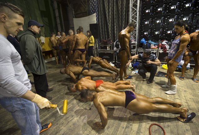 Participants prepare backstage during Belarus bodybuilding and fitness championship in Minsk April 25, 2015. (Photo by Vasily Fedosenko/Reuters)
