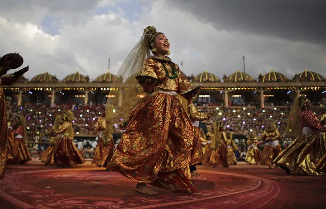 An artist from the Indian state of Sikkim performs at a massive three-day cultural festival organized by the Art of Living Foundation on the banks of the river Yamuna in New Delhi, India, Saturday, March 12, 2016. The festival opened on the banks of the Yamuna River in the Indian capital Friday despite concerns the sprawling construction of roads, ramps and pontoon bridges would irreparably damage the river's floodplains. (Photo by Altaf Qadri/AP Photo)