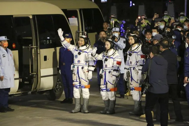 From left, Chinese astronauts Zhai Zhigang, Wang Yaping, and Ye Guangfu, wave before leaving for the Shenzhou-13 crewed space mission at the Jiuquan Satellite Launch Center in northwest China, October15, 2021. Shortly ahead of sending a new three-person crew to its space station, China on Friday renewed its commitment to international cooperation in the peaceful use of space. (Photo by Chinatopix via AP Photo)