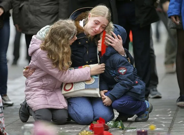 A woman consoles her children at a street memorial following Tuesday's bomb attacks in Brussels, Belgium, March 23, 2016. (Photo by Vincent Kessler/Reuters)