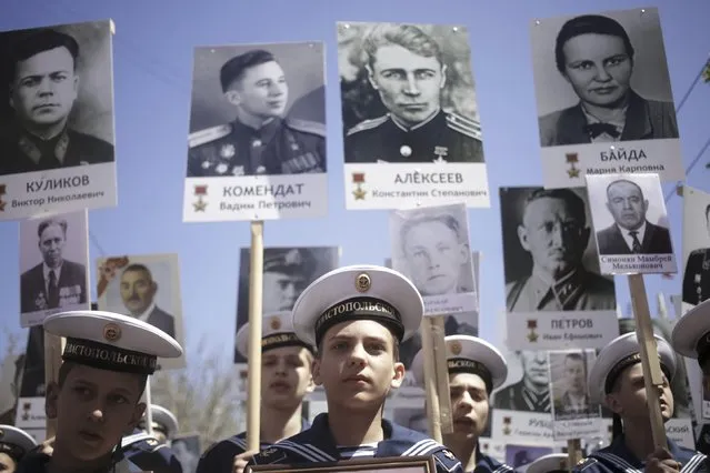 Students of the Sevastopol Presidential Cadet School hold pictures of World War Two soldiers as they take part in the Immortal Regiment march during the Victory Day celebrations in central Moscow, Russia, May 9, 2015. (Photo by Reuters/Host Photo Agency/RIA Novosti)
