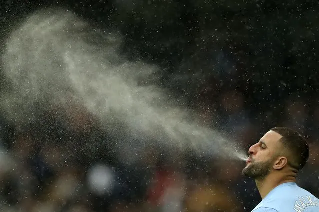 Manchester City's Kyle Walker completes his pre-match ritual of spitting water before the English Premier League soccer match between Manchester City and West Ham United at the Etihad stadium in Manchester, England, Sunday, November 28, 2021. (Photo by Scott Heppell/AP Photo)