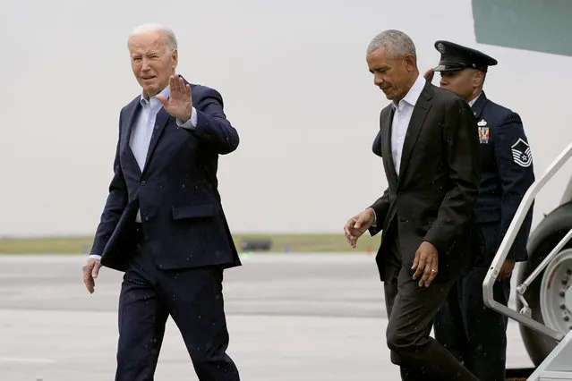 President Joe Biden waves as he arrives with former President Barack Obama, center, on Air Force One at John F. Kennedy International Airport, Thursday, March 28, 2024, in New York. (Photo by Alex Brandon/AP Photo)