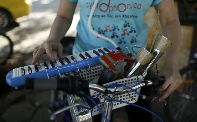 A musician from the Cyclophonica tests a melodica before a ride in Rio de Janeiro May 17, 2015. (Photo by Pilar Olivares/Reuters)