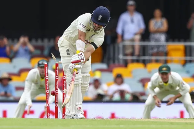 England's Rory Burns is out bowled first ball during day one of the first Ashes cricket test at the Gabba in Brisbane, Australia, Wednesday, December 8, 2021. (Photo by Tertius Pickard/AP Photo)