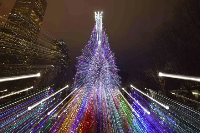 The Millennium Park Christmas tree is seen in a timed exposure with zoom lens Wednesday, December 15, 2021, in Chicago. (Photo by Charles Rex Arbogast/AP Photo)