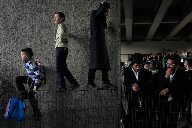 Ultra-Orthodox Jews block a highway during a protest against army recruitment, near Bnei Brak, Israel, on Monday, April 1, 2024. Ultra-Orthodox men have long received exemptions from military service, which is compulsory for most Jewish men, generating widespread resentment. The Supreme Court has ordered the government to present a new proposal to force more religious men to enlist. (Photo by Ariel Schalit/AP Photo)