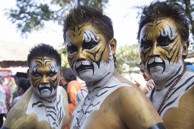 The tigers dancer pose for a photo that made them look like “KISS” rock band team on May 21, 2015 in Tugu, East Java, Indonesia. “Bantengan” is Malang-East Java traditional dance that perform the fighting between bull and tiger, both dancers who perform as Bull or Tigers will get the bull and tiger aura that made them look like those animals and fight each other, the dance end when the tigers beat the bull. (Photo by Donal Husni/ZUMA Wire/ZUMAPress)