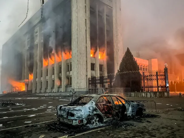 A burnt car is seen by the mayor’s office on fire in Almaty, Kazakhstan on January 5, 2022. Protests are spreading across Kazakhstan over the rising fuel prices; protesters broke into the Almaty mayor’s office and set it on fire. (Photo by Valery Sharifulin/TASS)