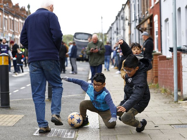 Children play football outside Kenilworth Road, home to Luton Town, before the Premiership side's match with Brentford in Luton, Britain on April 20, 2024. Luton remain in the relegation zone after losing by 1-5, while Brentford rise to mid-table safety. (Photo by Peter Cziborra/Action Images via Reuters)