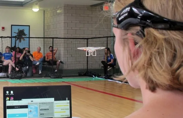 In this April 16, 2016 photo. a University of Florida student uses a brain-controlled interface headset to fly a drone during a mind-controlled drone race in Gainesville, Fla. For more than a century science has been able to detect brainwaves, but recent advances in cheaper equipment like the electroencephalogram, or EEG, headsets worn by the drone racers is moving the technology out of the lab. (Photo by Jason Dearen/AP Photo)