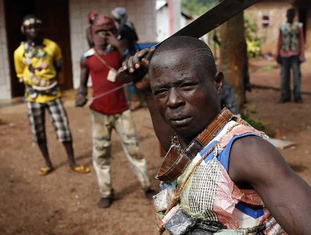 A member of the anti-balaka, a Christian militia, poses with his machete in village of Zawa April 8, 2014. (Photo by Goran Tomasevic/Reuters)