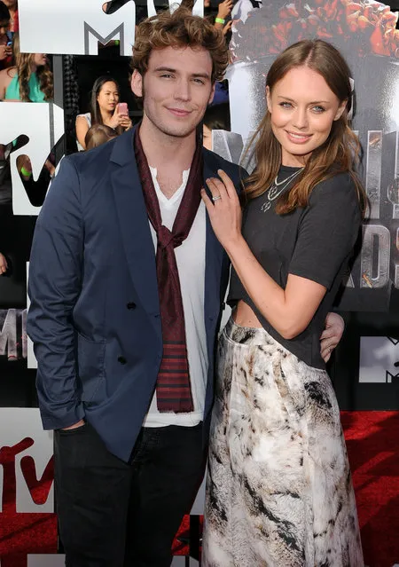 Actors Sam Claflin (L) and Laura Haddock attend the 2014 MTV Movie Awards at Nokia Theatre L.A. Live on April 13, 2014 in Los Angeles, California. (Photo by Steve Granitz/WireImage)