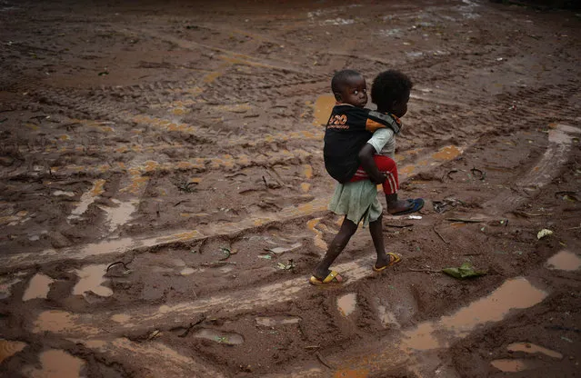Children walk during rain in front of Saint Michel Catholic church in the town of Boda April 14, 2014. (Photo by Goran Tomasevic/Reuters)