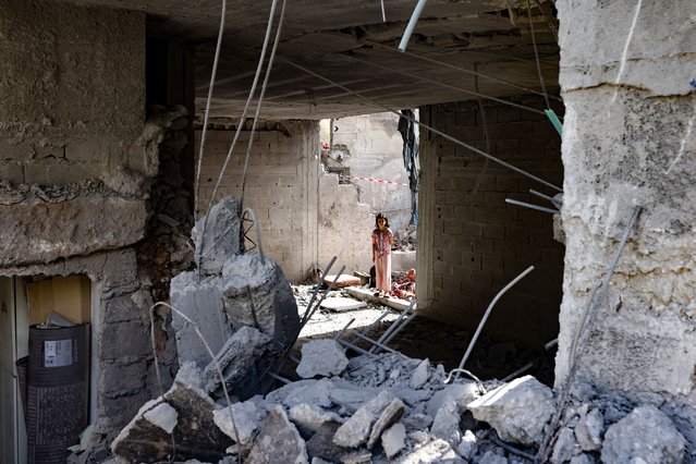 A Palestinian child stares at the rubble of a building hit by an overnight Israeli strike in the occupied West Bank Jenin refugee camp, in an attack during which Al-Quds Brigade, the armed wing of militant group Palestinian Islamic Jihad, said local commander Islam Khamayseh was killed, on May 18, 2024. (Photo by Zain Jaafar/AFP Photo)