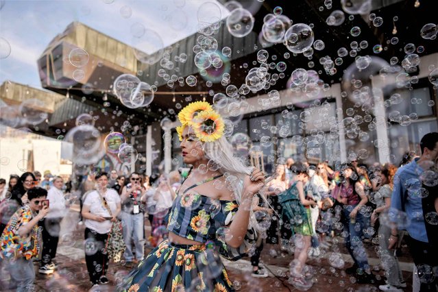 A participant dances among soap bubbles during the Pride Parade in Pristina, on June 10, 2023. Members of the LGBTQ community took part in a Pride Parade in Pristina to demand “freedom” and “equal rights” in Kosovo's largely conservative society. (Photo by Armend Nimani/AFP Photo)