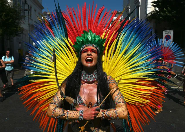 A performer in costume takes part in the carnival on the main Parade day of the Notting Hill Carnival in west London on August 26, 2019. Nearly one million people were expected by the organisers Sunday and Monday in the streets of west London's Notting Hill to celebrate Caribbean culture at a carnival considered the largest street demonstration in Europe. (Photo by Daniel Leal-Olivas/AFP Photo)