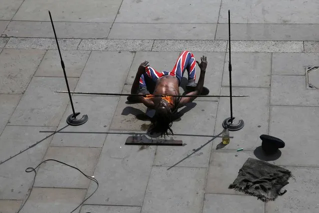 A busker performs at Trafalgar Square in London, Britain May 6, 2016. (Photo by Stefan Wermuth/Reuters)