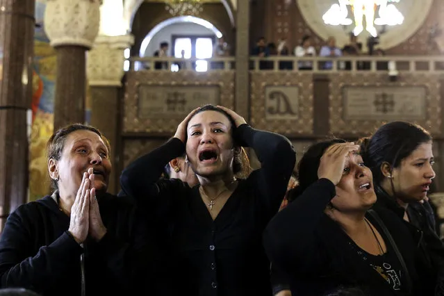 Women cry during the funeral for those killed in a Palm Sunday church attack in Alexandria Egypt, at the Mar Amina church, Monday, April 10, 2017.  Egyptian Christians were burying their dead on Monday, a day after Islamic State suicide bombers killed at least 45 people in coordinated attacks targeting Palm Sunday services in two cities. Women wailed as caskets marked with the word “martyr” were brought into the Mar Amina church in the coastal city of Alexandria, the footage broadcast on several Egyptian channels. (Photo by Samer Abdallah/AP Photo)