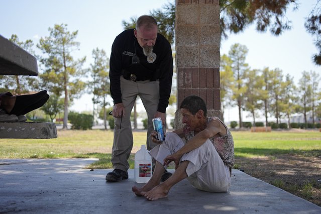 Mark Paulson, a Public Response and Code Enforcement officer, checks on Deb Billet, 66, before calling an ambulance to take her to a hospital for heat-related symptoms Wednesday, July 10, 2024, in Henderson, Nev. Billet has been living on the street. About 14 officers from the Office of Public Response drove around the city Wednesday offering water, electrolytes, free bus tickets and rides to cooling centers during a heat emergency. (Photo by John Locher/AP Photo)