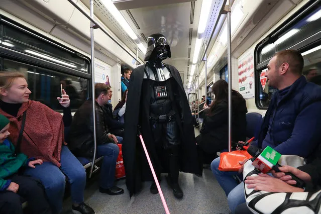 A man dressed as Darth Vader participates in a Star Wars Day flash mob on a metro train in Moscow, Russia on May 4, 2017. (Photo by Vyacheslav Prokofyev/TASS)