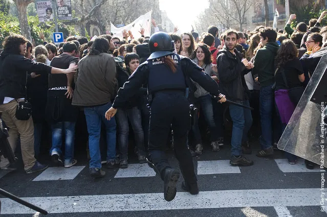 Riot Police clash with student demonstrators during a demonstration on February 2012 in Barcelona