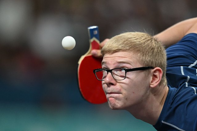 France's Felix Lebrun eyes the ball while serving during his men's table tennis singles match in the team semifinal between China and France at the Paris 2024 Olympic Games at the South Paris Arena in Paris on August 8, 2024. (Photo by Jung Yeon-Je/AFP Photo)