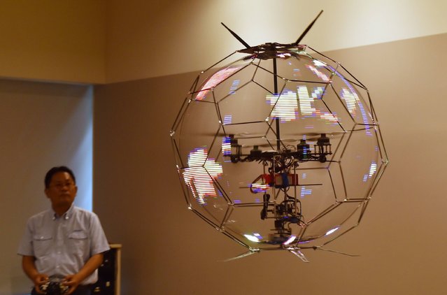 Japan's NTT DOCOMO demonstrates a spherical drone display, an unmanned aerial vehicle that displays LED images on an omnidirectional spherical screen while in flight, at the company's research laboratories in Yokosuka, Kanagawa prefecture on May 29, 2017. (Photo by Kazuhiro Nogi/AFP Photo)