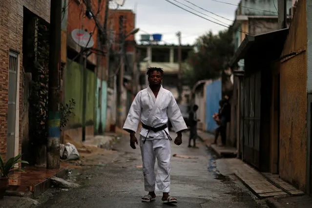 Popole Misenga, a refugee from the Democratic Republic of Congo and a judo athlete, poses for a photo near his home in a slum in Rio de Janeiro, Brazil, June 2, 2016. (Photo by Pilar Olivares/Reuters)