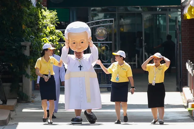 A Thai man dressed in a Pope Francis costume walks inside the grounds of the St Louis Church before the Pope's arrival at the Apostolic Nunciature Embassy of the Holy See in Bangkok, Thailand, 20 November 2019. Pope Francis has begun his three-day visit to Thailand, which runs from 20 to 23 November 2019. It will mark the 350th anniversary of the founding of the “Mission de Siam” and is aimed at promoting inter-religious dialogue. Francis is the first pontiff to visit Thailand in nearly four decades. It will be the second papal to visit Thailand after the late John Paul II in 1984. (Photo by Diego Azubel/EPA/EFE)