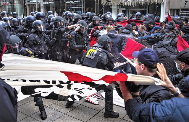 Police units and protesters clash during a Labor Day rally in Stuttgart, Germany, Monday, May 1, 2023. This year, the events of the German Federation of Trade Unions on Labor Day were held under the motto “Unbroken Solidarity”. (Photo by Christoph Schmidt/dpa via AP Photo)