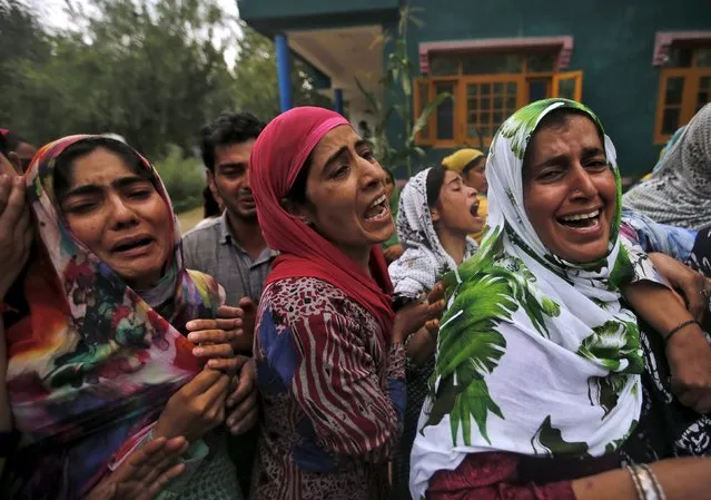 Relatives weep during the funeral procession of a civilian, Bilal Ahmad Bhat, at Padgampora village in Pulwama district, south of Srinagar, August 12, 2015. (Photo by Danish Ismail/Reuters)